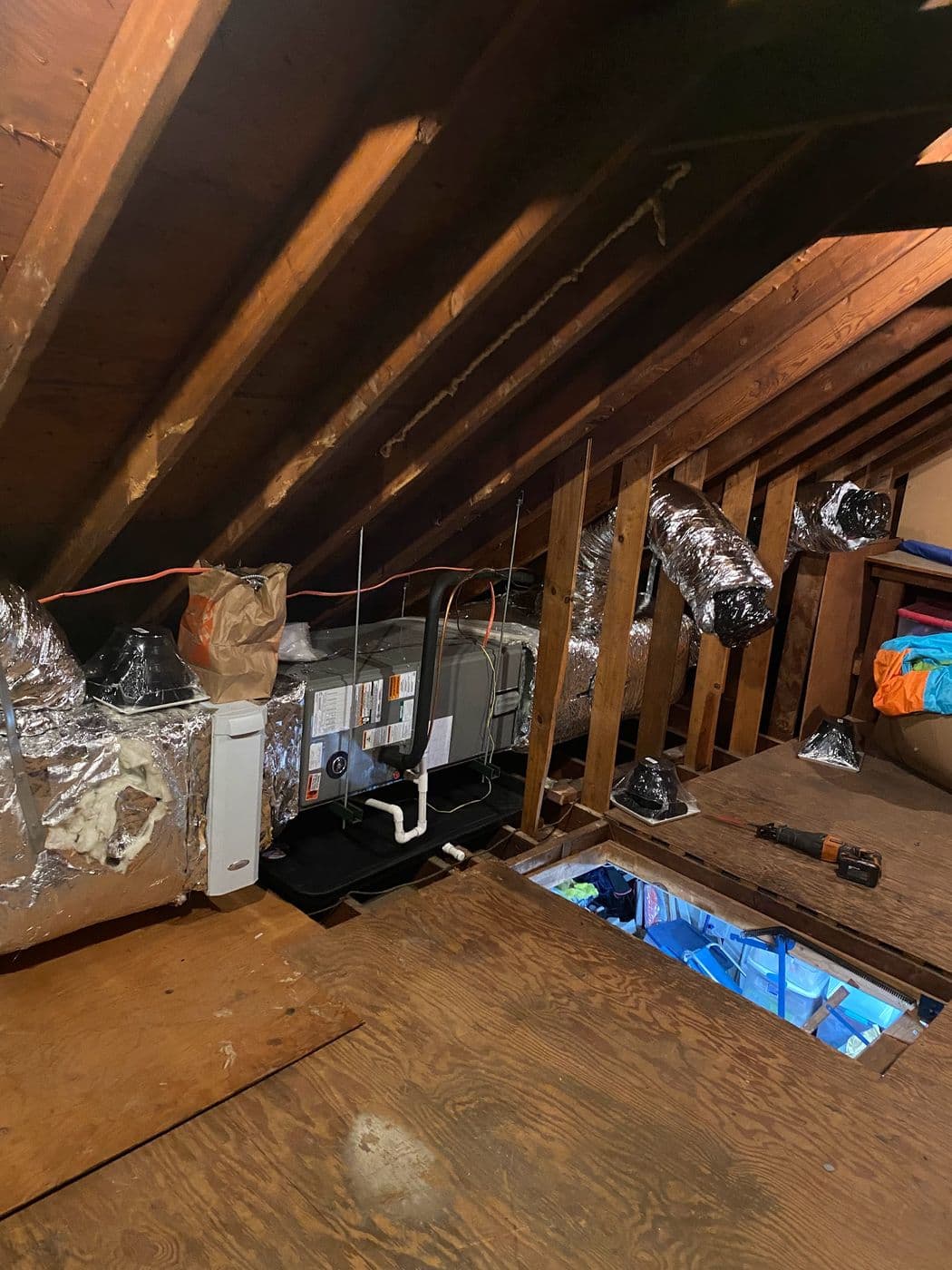 Newly run attic ductwork and a relocated air handler