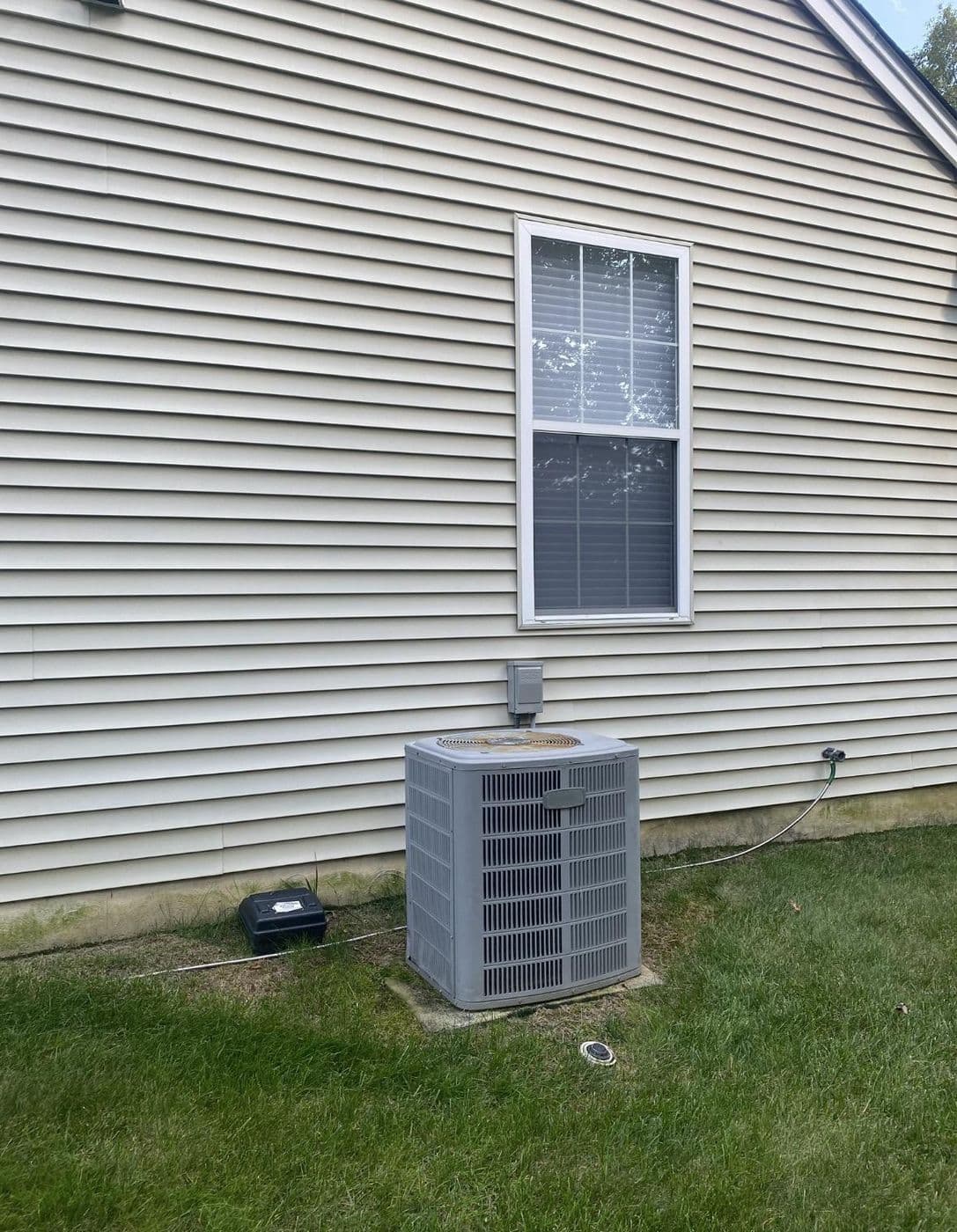 The original outdoor condenser before replacement