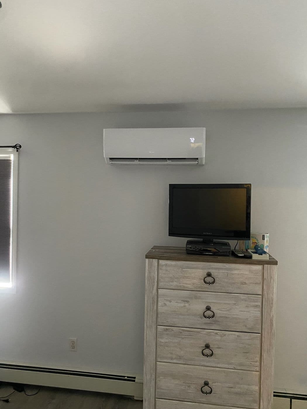 A ductless mini split head mounted in a bedroom